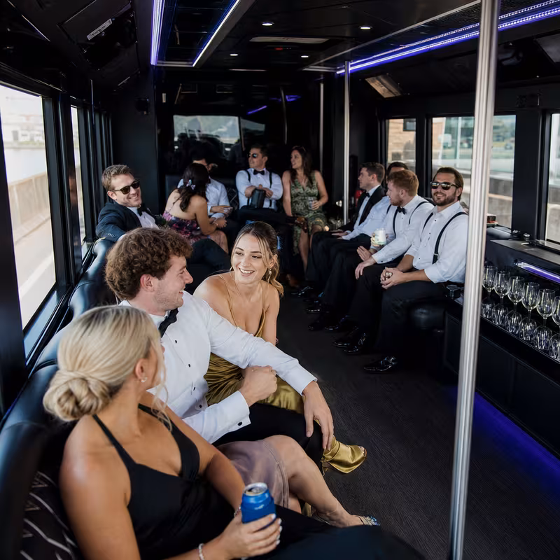 Wedding guests seated inside a New Orleans party bus