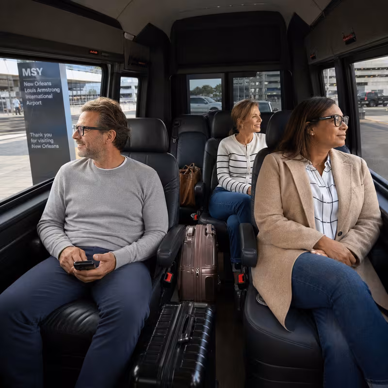 Passengers loading luggage while boarding an New Orleans group shuttle