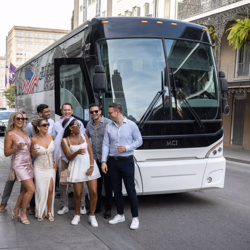 Passengers loading luggage while boarding an New Orleans group shuttle