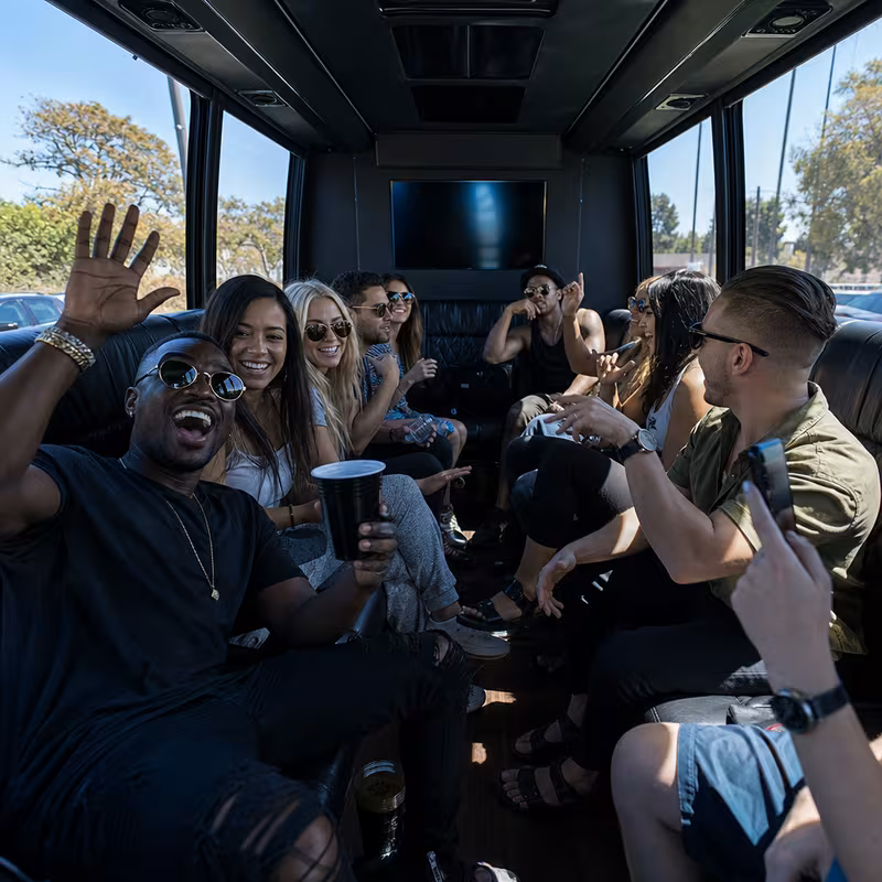 Group boarding a white charter bus for Concert Transportation transportation in New Orleans