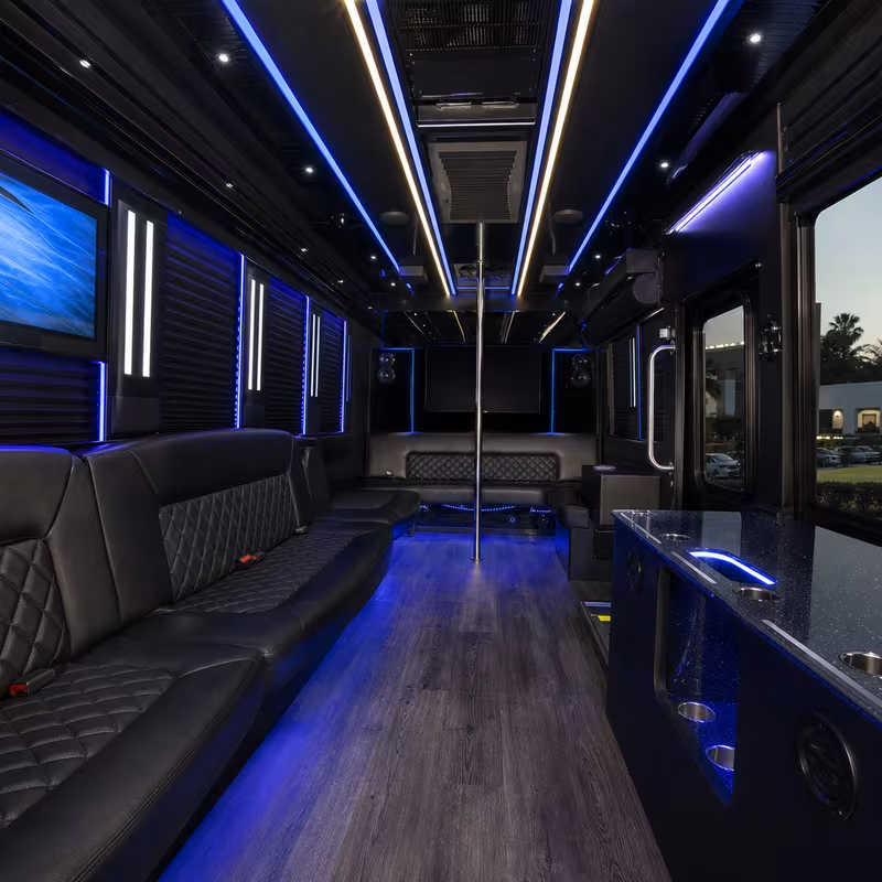 Party bus interior with wraparound leather seating and LED lighting in New Orleans