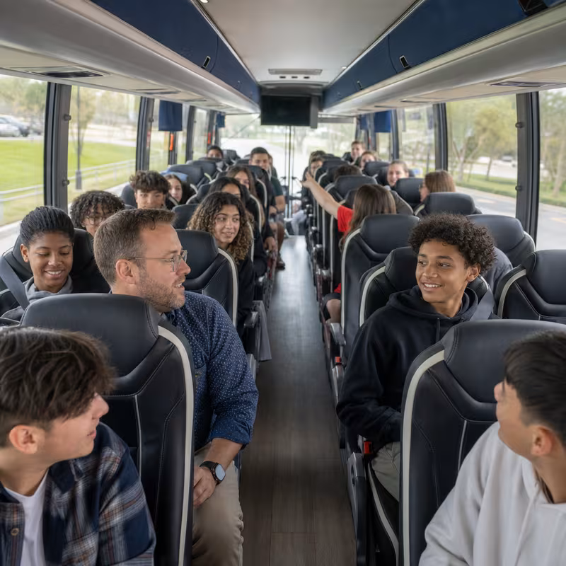 Group boarding a white charter bus for School Transportation transportation in New Orleans