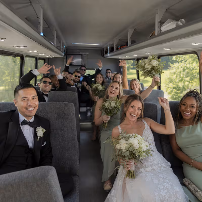 Group boarding a white charter bus for Wedding Transportation transportation in New Orleans
