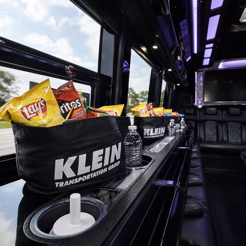 Party bus interior with wraparound leather seating and LED lighting in New Orleans